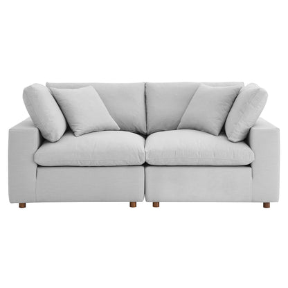 Light gray fabric 2-piece sectional sofa set with loose back cushions, two matching throw pillows, and short wooden legs.