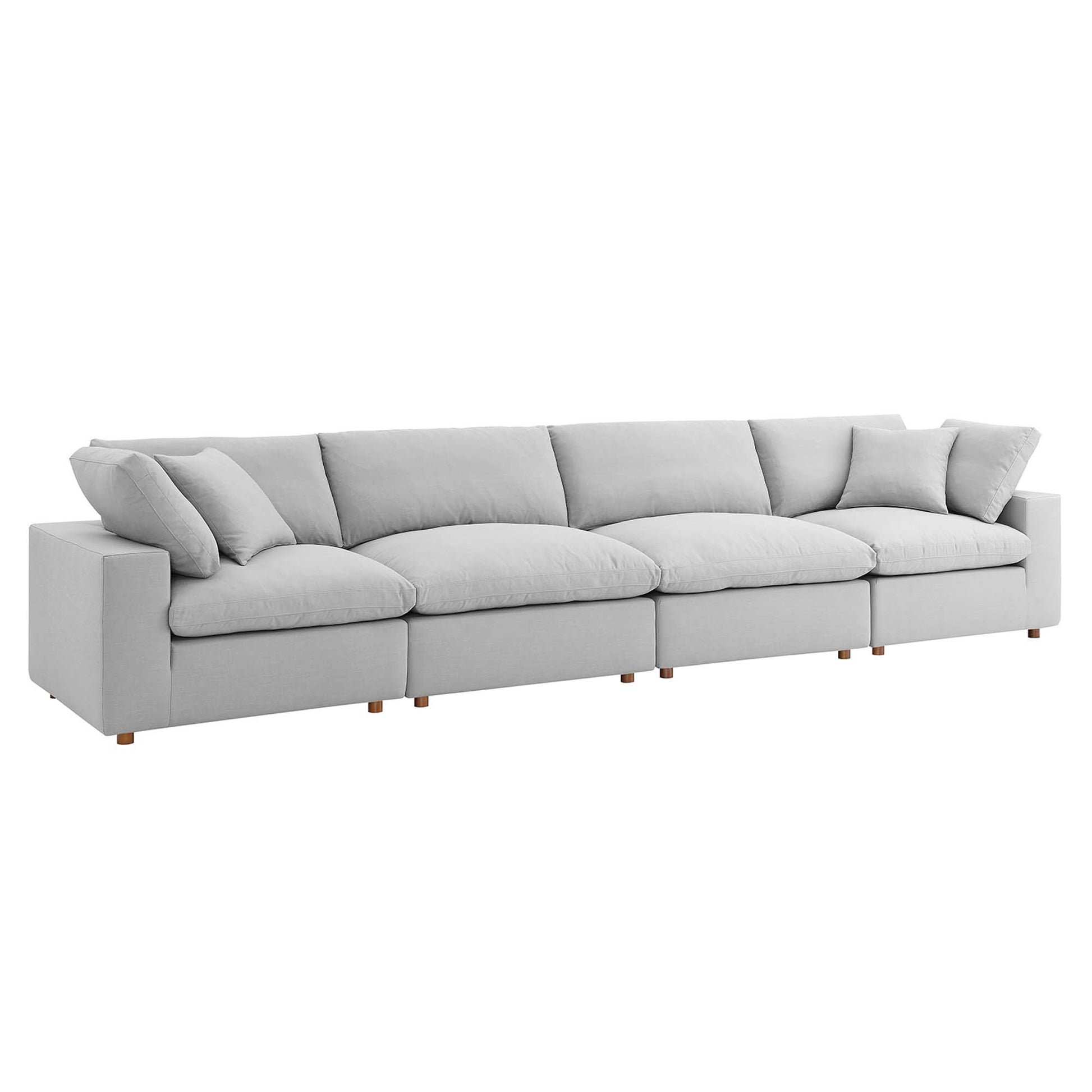 Light gray fabric modular sectional sofa with plush back and seat cushions and wooden legs.