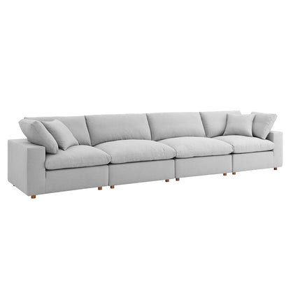 Light gray fabric modular sectional sofa with plush back and seat cushions and wooden legs.