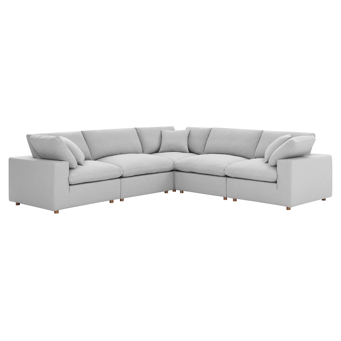 Light gray fabric L-shaped sectional sofa with plush cushions and short wooden legs.