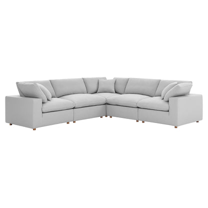 Light gray fabric L-shaped sectional sofa with plush cushions and short wooden legs.