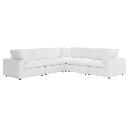 White fabric L-shaped sectional sofa with deep cushions and wooden block feet, modern living room seating.