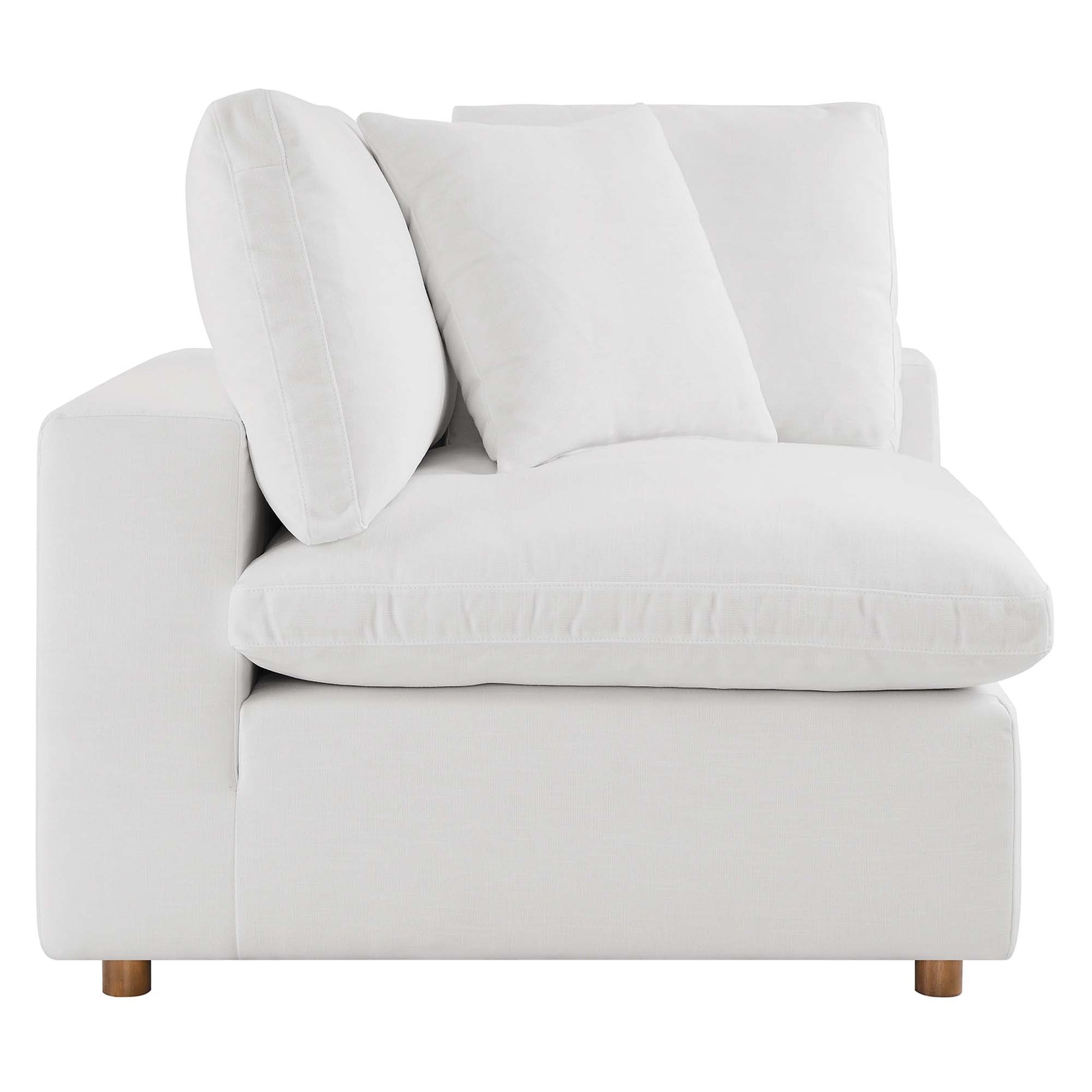 Off-white fabric armless sectional sofa with overstuffed cushions.