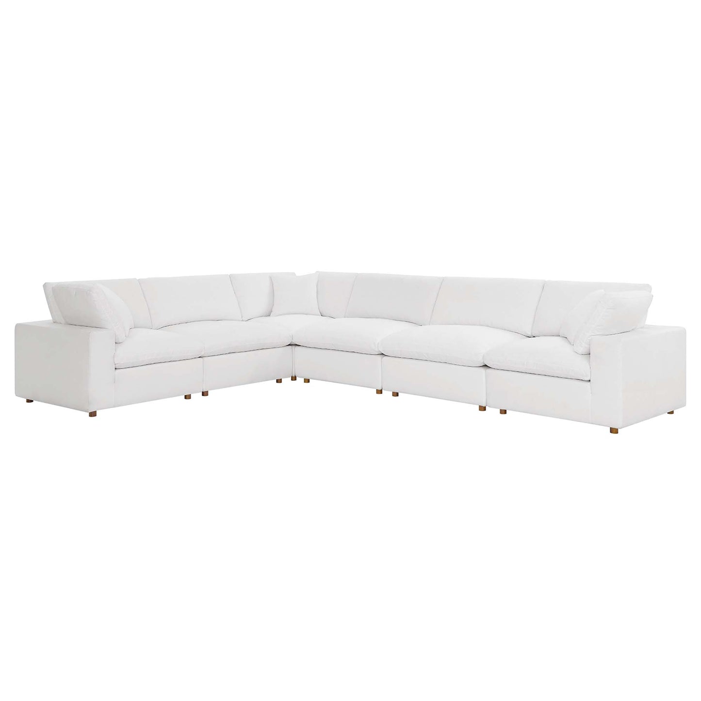 White fabric-covered L-shaped sectional with plush cushions and short wooden legs for a modern living room.