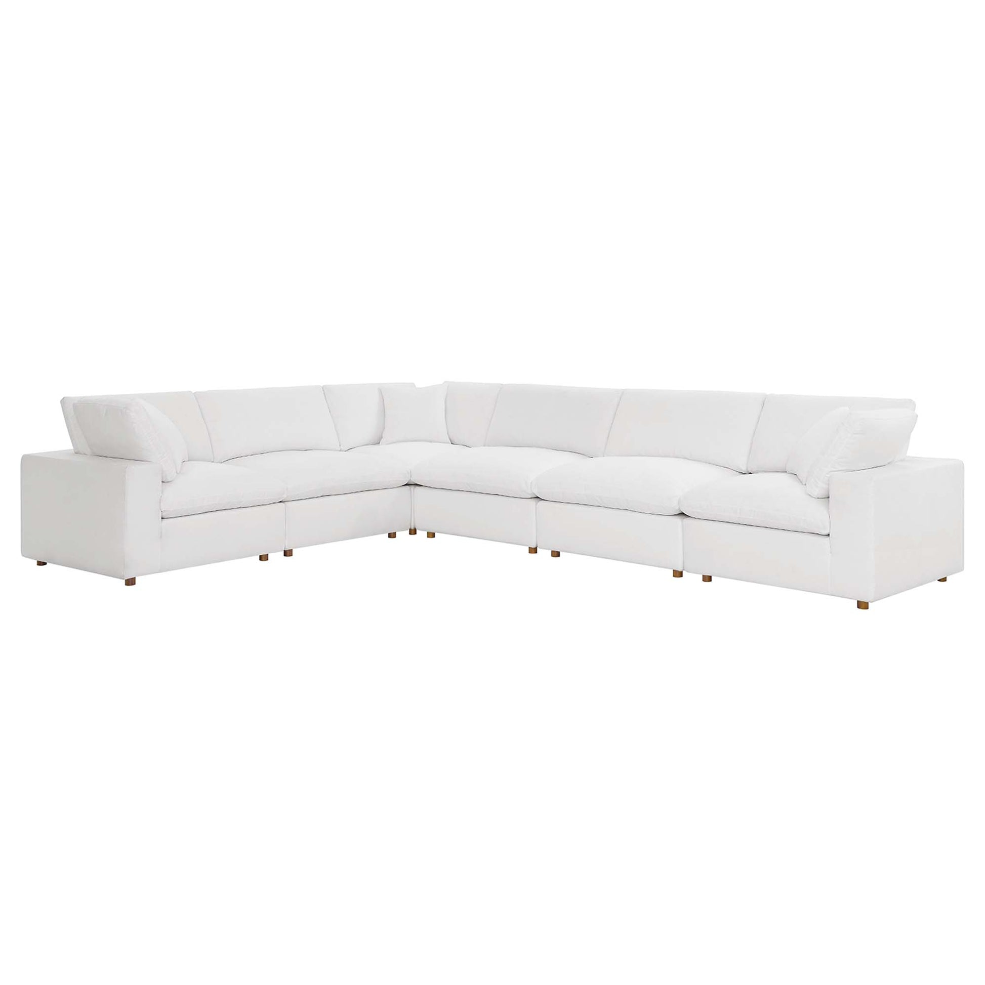 White fabric-covered L-shaped sectional with plush cushions and short wooden legs for a modern living room.