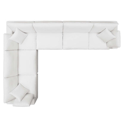 White fabric sectional sofa in an L-shape with matching cushions and a chaise on the left.