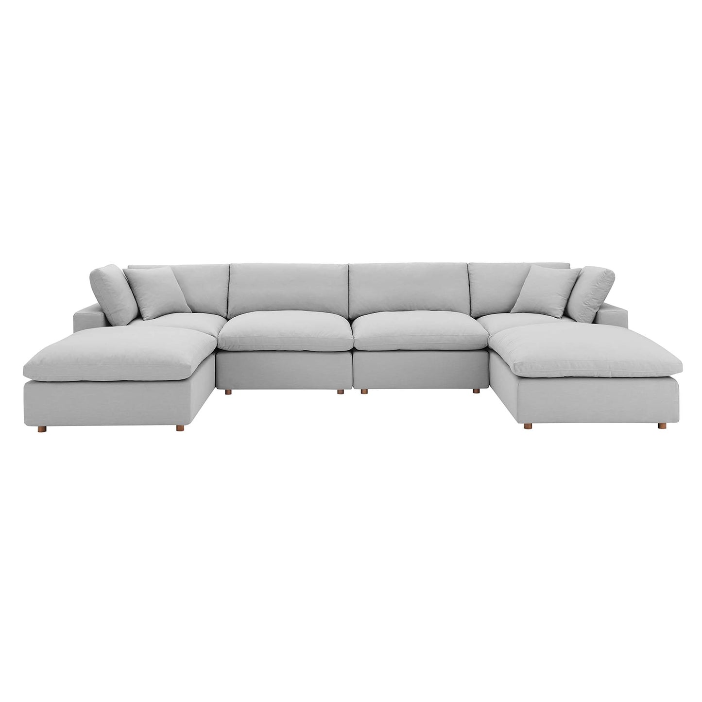Light gray fabric sectional sofa with chaise ends, modular, plush cushions, low wooden legs.