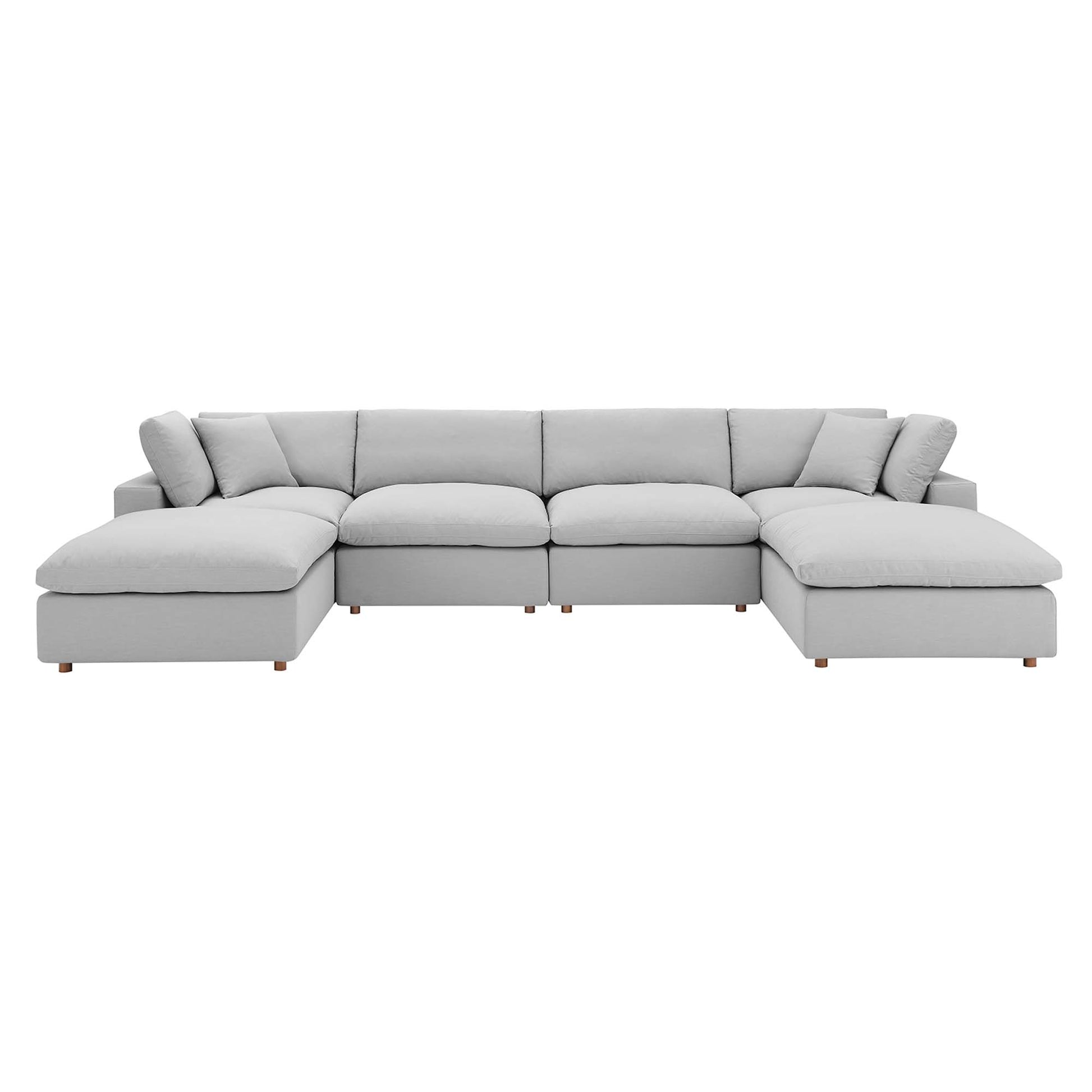 Light gray fabric sectional sofa with chaise ends, modular, plush cushions, low wooden legs.