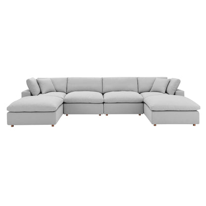 Light gray fabric sectional sofa with chaise ends, modular, plush cushions, low wooden legs.