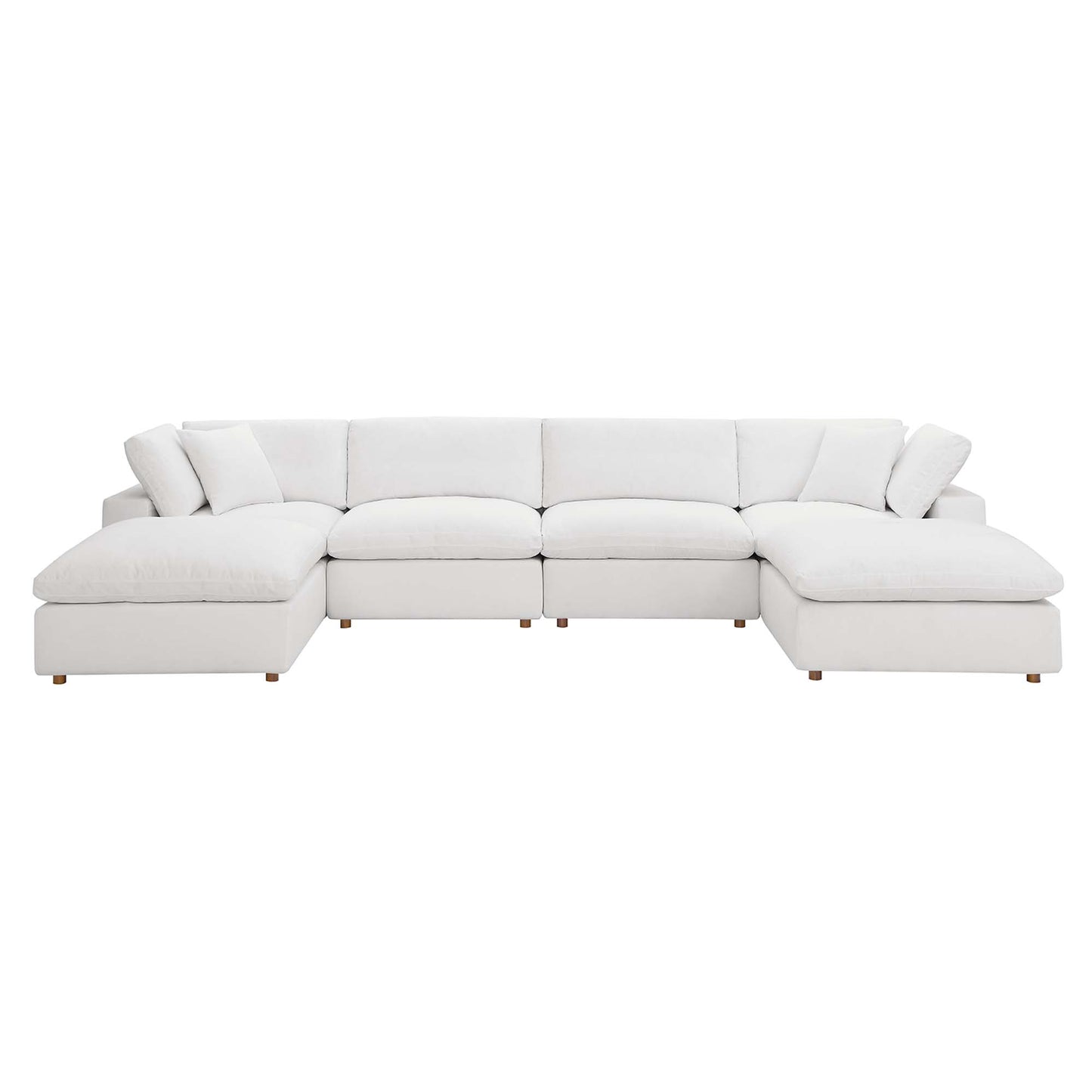 White fabric sectional sofa with chaise on both ends, plush cushions, and short wooden legs.