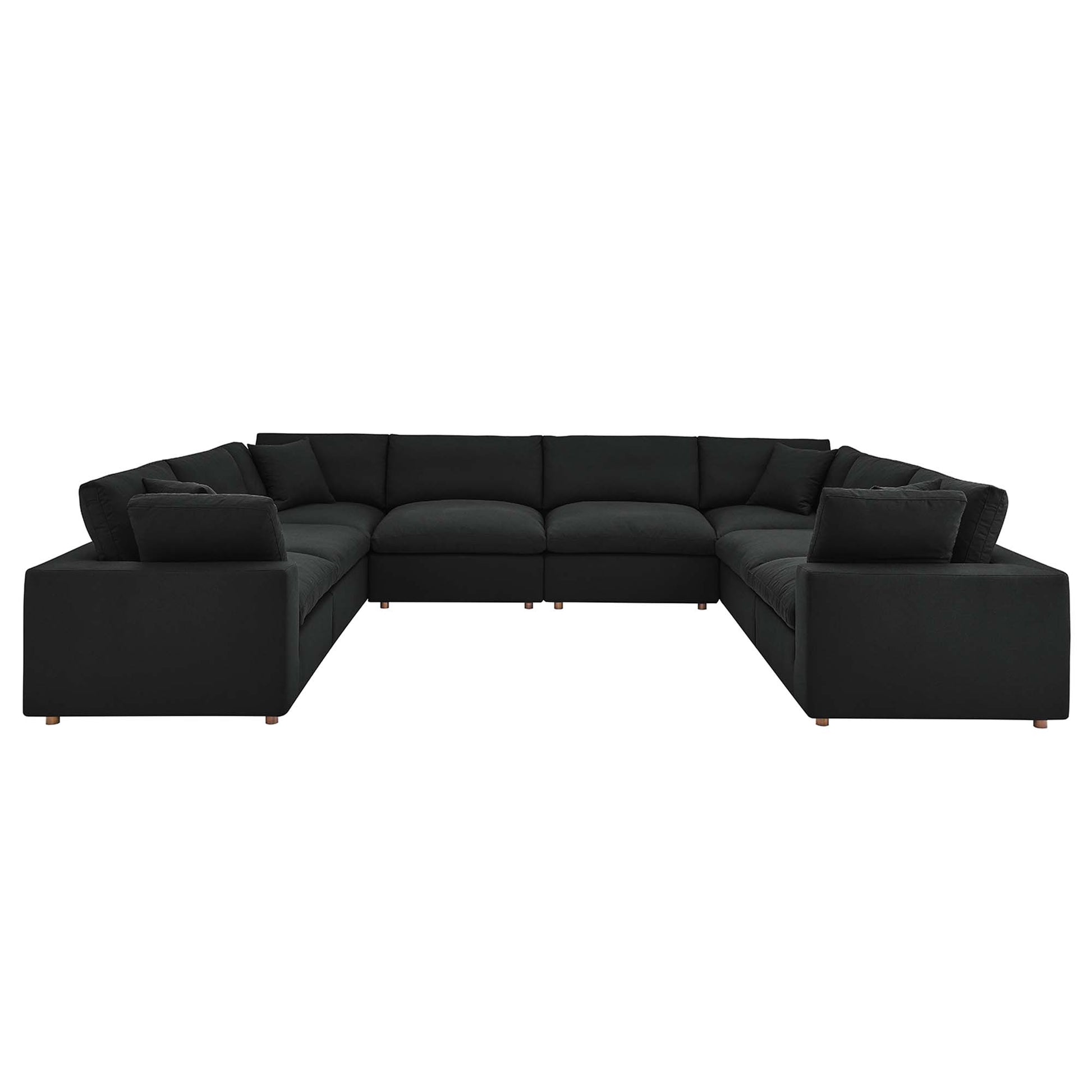 Large black fabric sectional sofa, L-shaped with thick cushions and wooden legs; modern modular living room seating.
