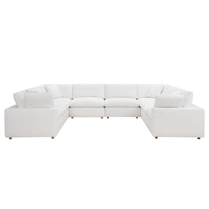White fabric modular L-shaped sectional sofa with plush cushions and short wooden legs.