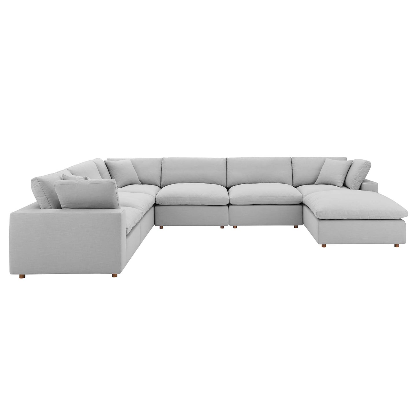 Light gray L-shaped sectional sofa with chaise on the right, plush cushions, and short wooden legs.