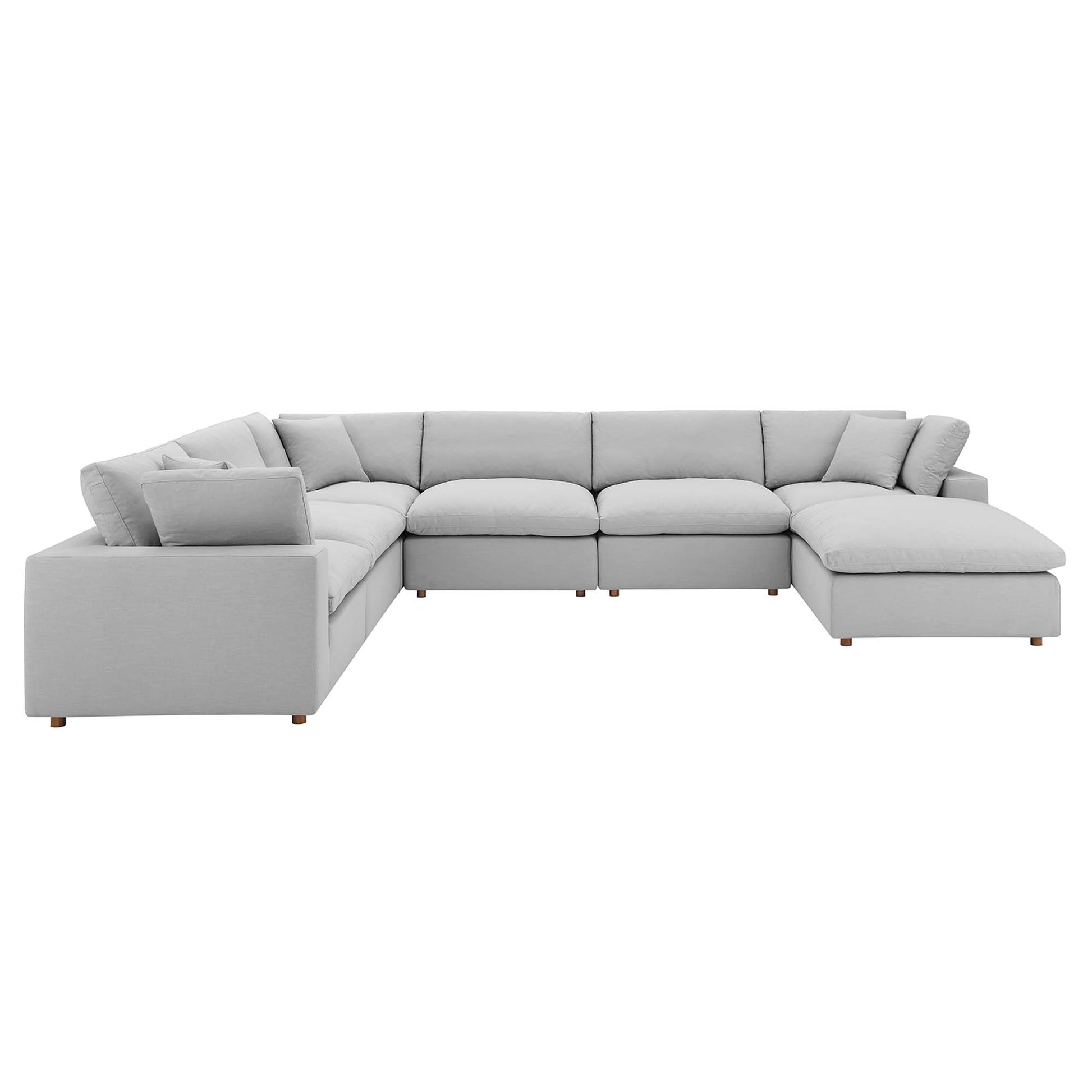 Light gray L-shaped sectional sofa with chaise on the right, plush cushions, and short wooden legs.