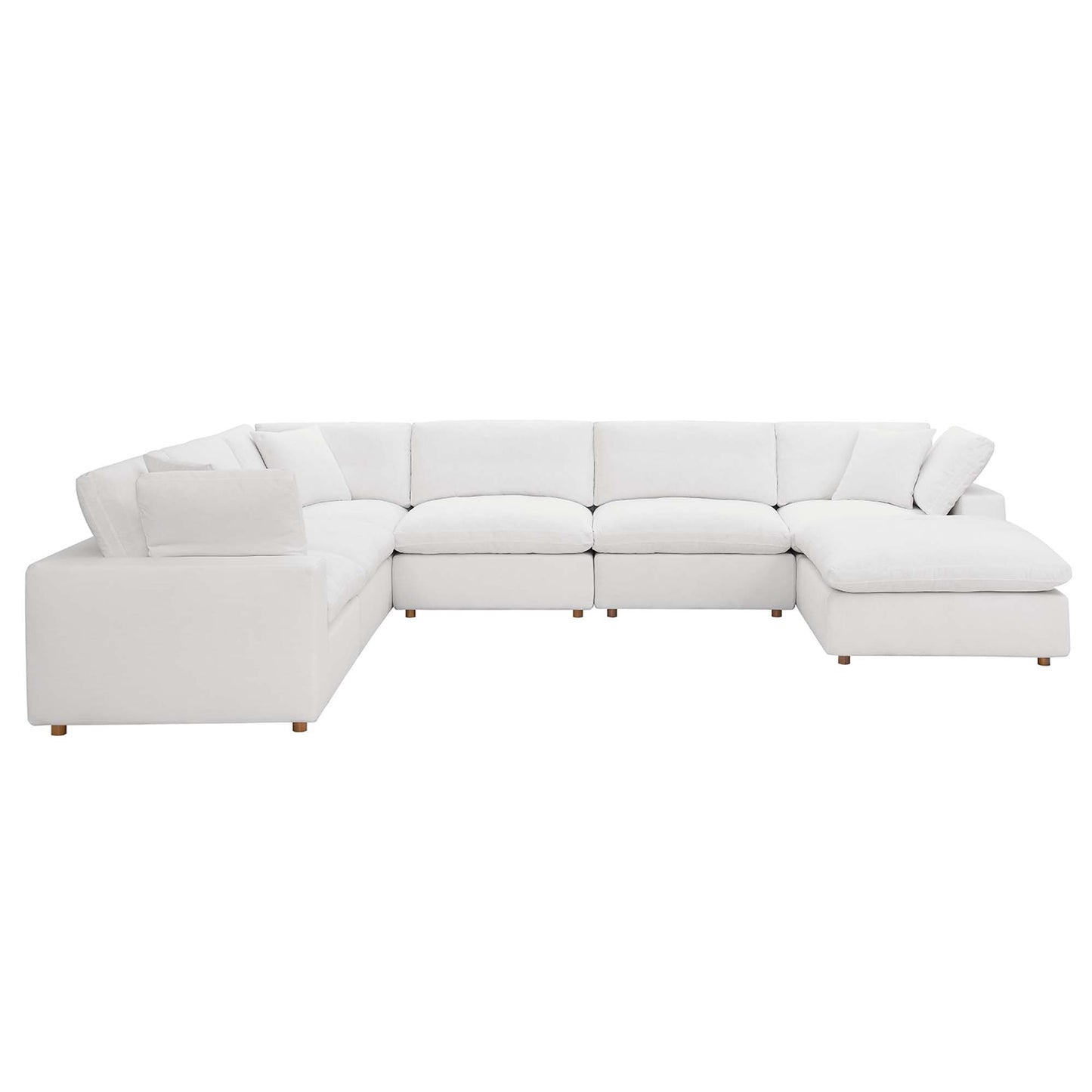 White fabric sectional sofa with chaise on the right, modular cushions and low wooden legs.