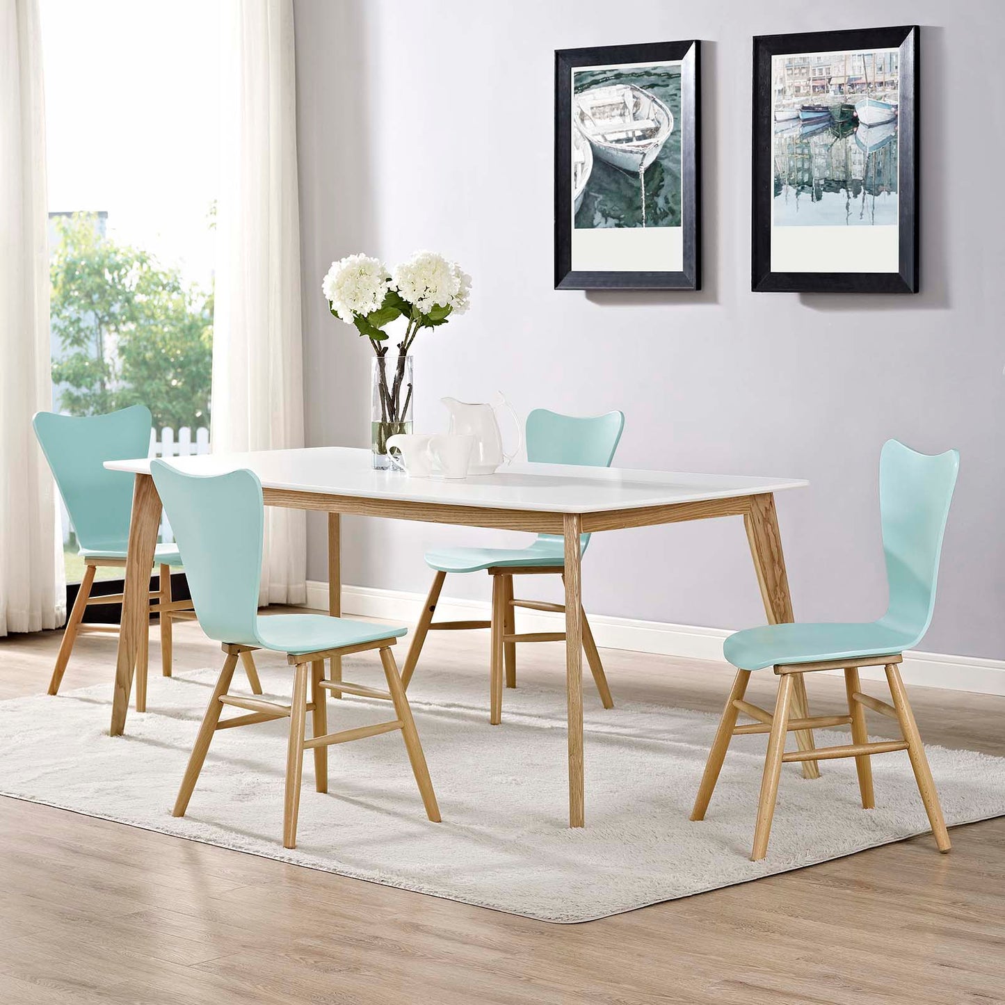 Set of four light blue dining chairs with natural wood legs.