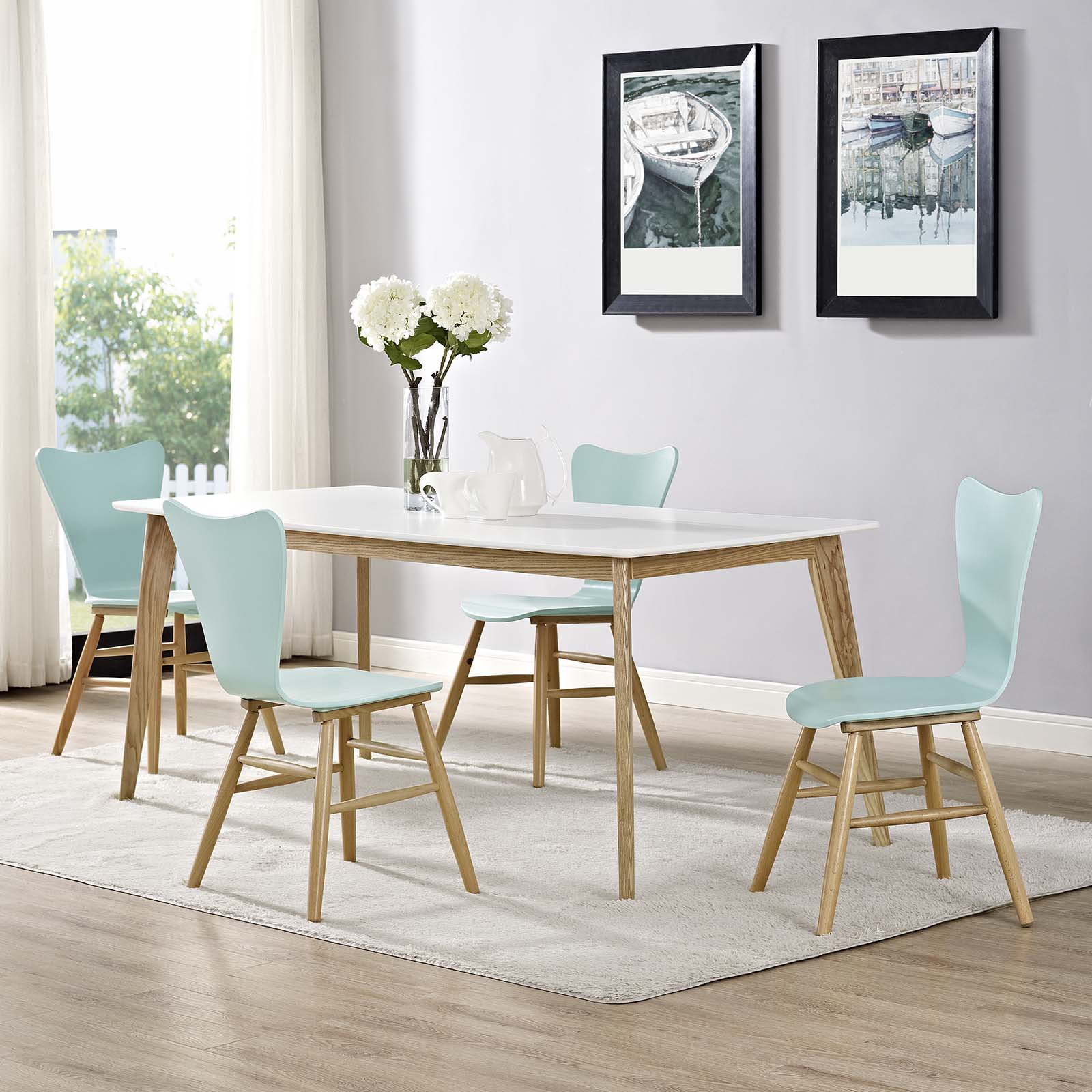 Set of four light blue dining chairs with natural wood legs.