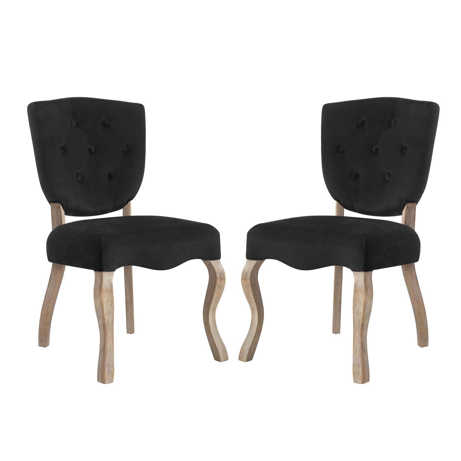 Pair of black button-tufted dining chairs with curved natural wood legs.