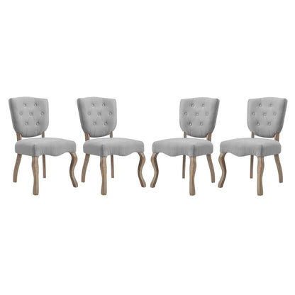 Set of four gray tufted fabric dining chairs with curved natural wood legs and button-back upholstery.
