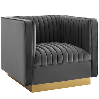 Dark gray velvet vertical-channel tufted accent armchair with a gold metal platform base.