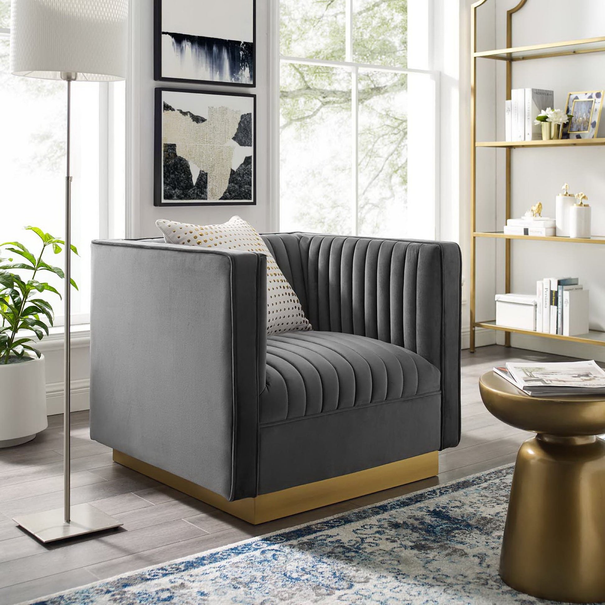 Grey velvet vertical channel-tufted armchair in a bright modern living room.