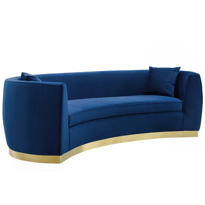 Navy velvet curved sofa with gold metal base, low arms, and two matching cushions