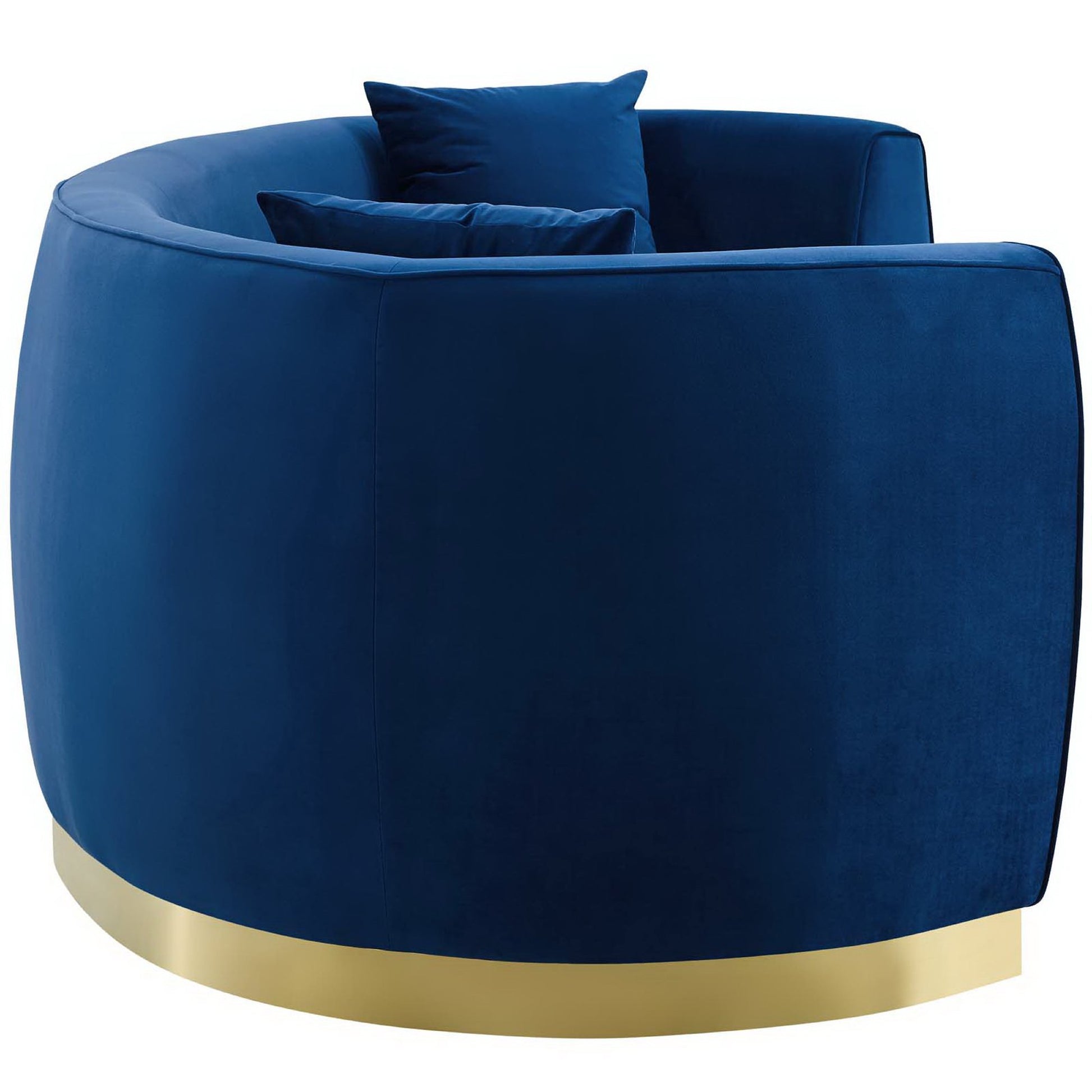 Navy blue curved velvet sofa with a gold metal base and cushions