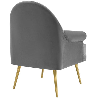 Grey velvet accent armchair with curved back, plush cushions, and gold tapered legs.