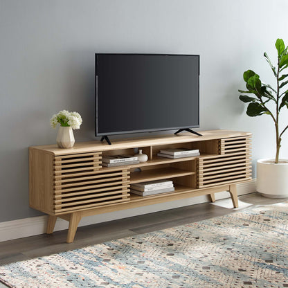 Light oak mid-century TV stand with slatted doors and open shelves, holding a flat-screen TV; plant on top.