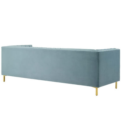 Blue velvet sofa with tufted back, low-profile design & gold legs.