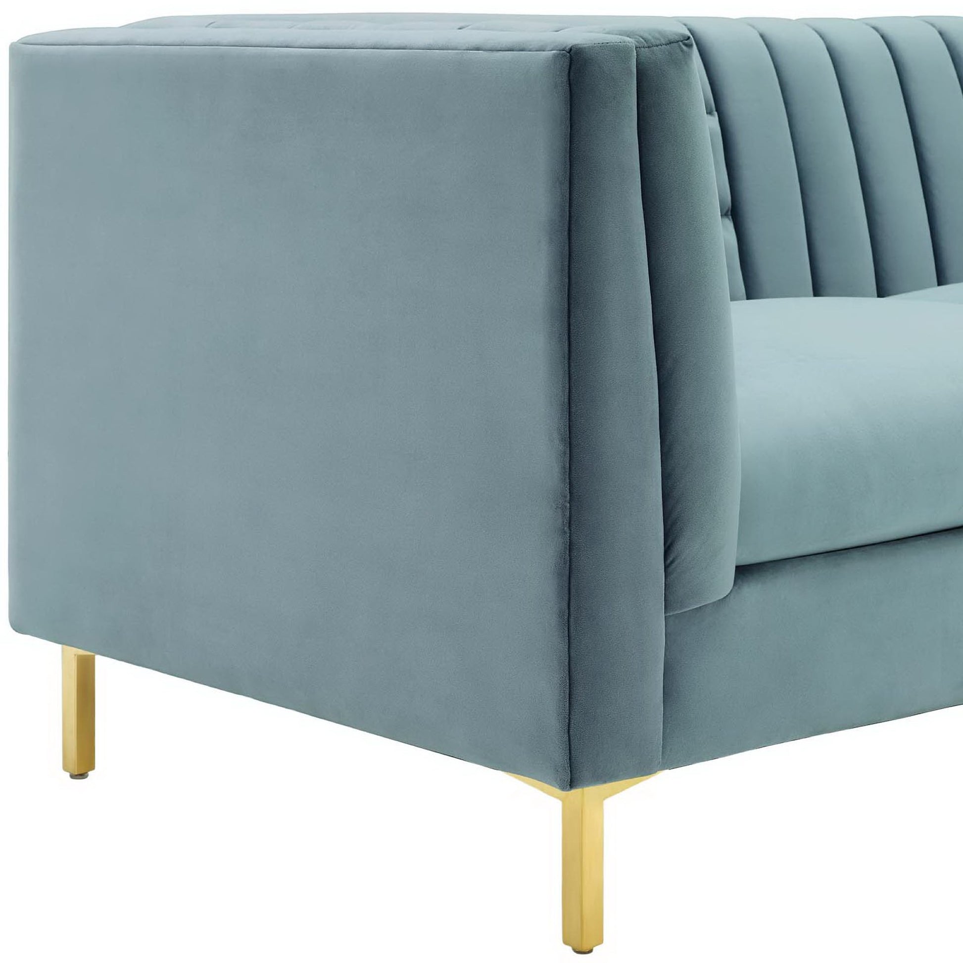 Blue velvet sofa with gold metal legs, square arms, and vertical channel tufting for a modern look.