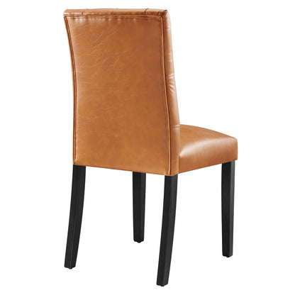 Tan vinyl dining chair with padded back and seat, black wooden legs.