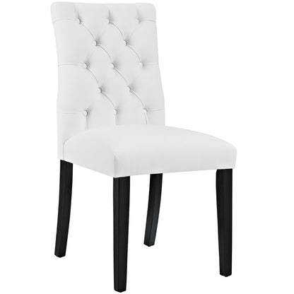 White tufted dining chair with tall back, buttoned upholstery, cushioned seat, and dark wood legs.