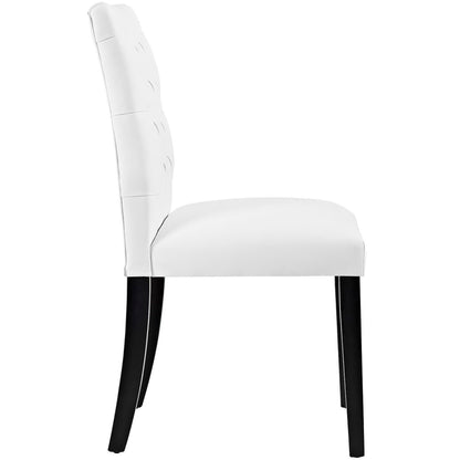 White vinyl dining chairs with tufted backs, cushioned seats, black legs.