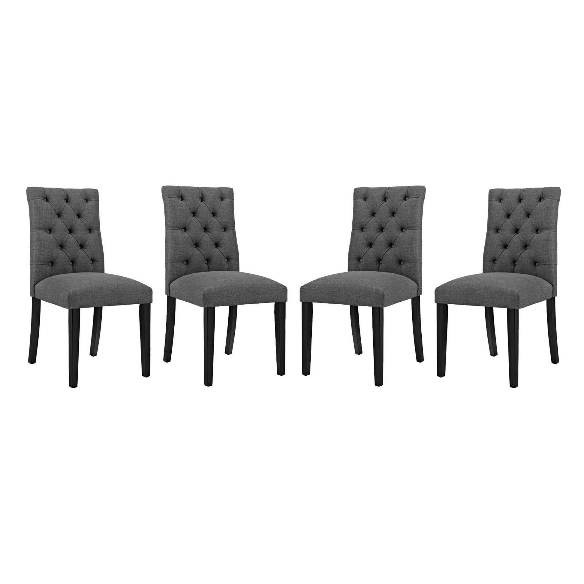Set of four gray fabric dining chairs with tufted backs and dark wood legs.