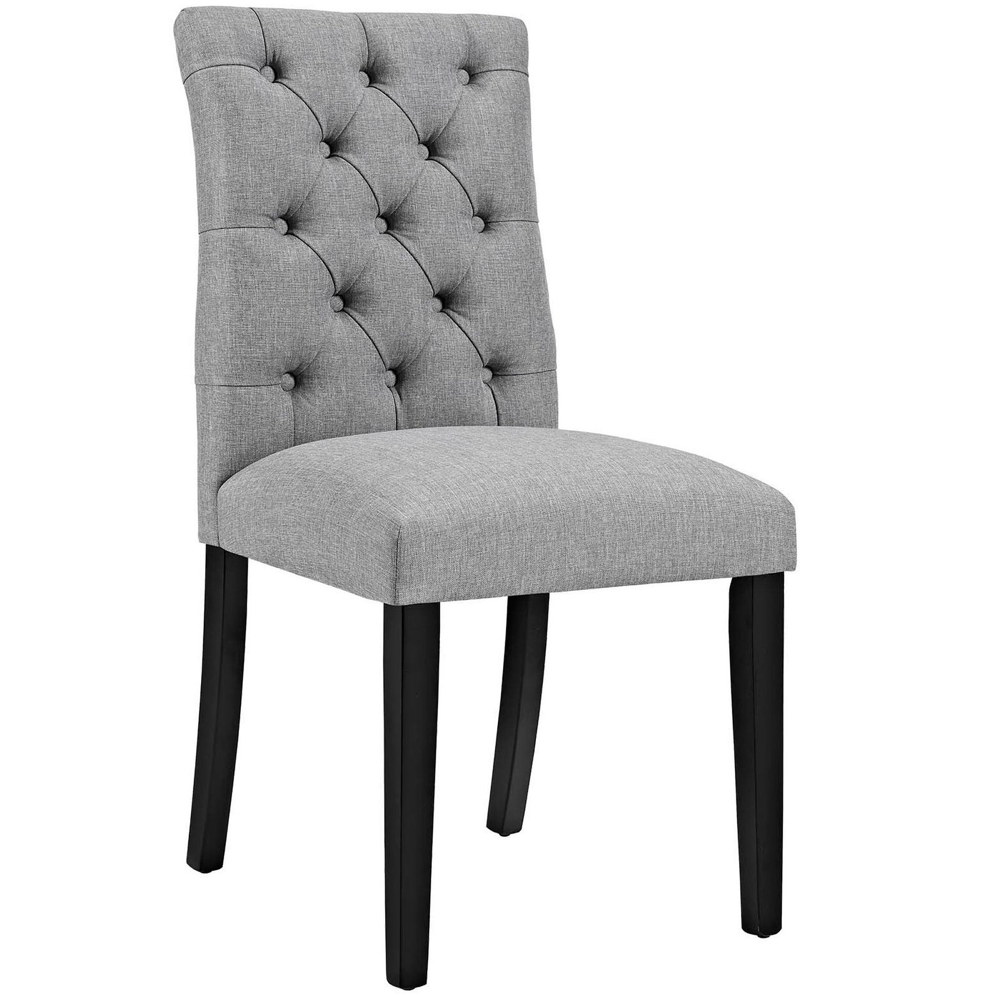 Light gray upholstered dining chair with button-tufted back, padded seat, and dark wood legs.