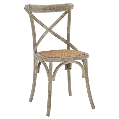 Pair of distressed gray wooden dining chairs with woven cane seats and crisscross X-back design.