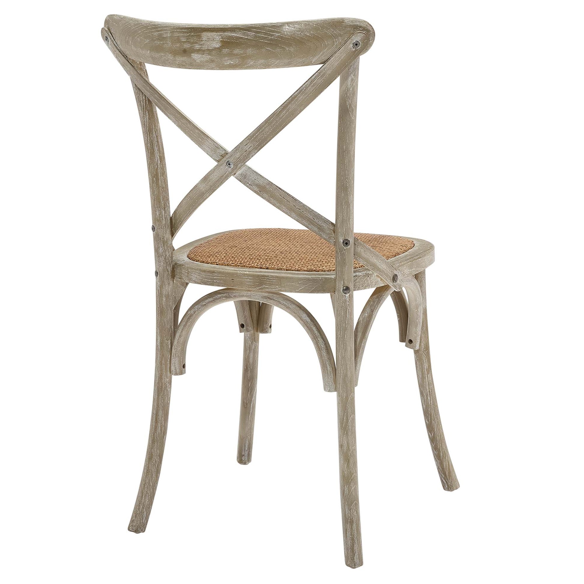 Weathered gray wooden dining chair with X-back and woven cane seat.