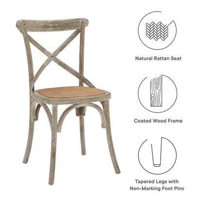 Rustic gray-washed dining side chair with natural rattan seat, cross back, and tapered coated wood legs; set of 2.