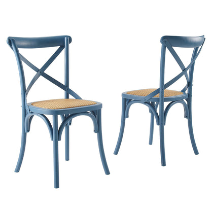 Pair of blue bistro chairs with woven cane seats, X-back crisscross supports and curved metal legs.