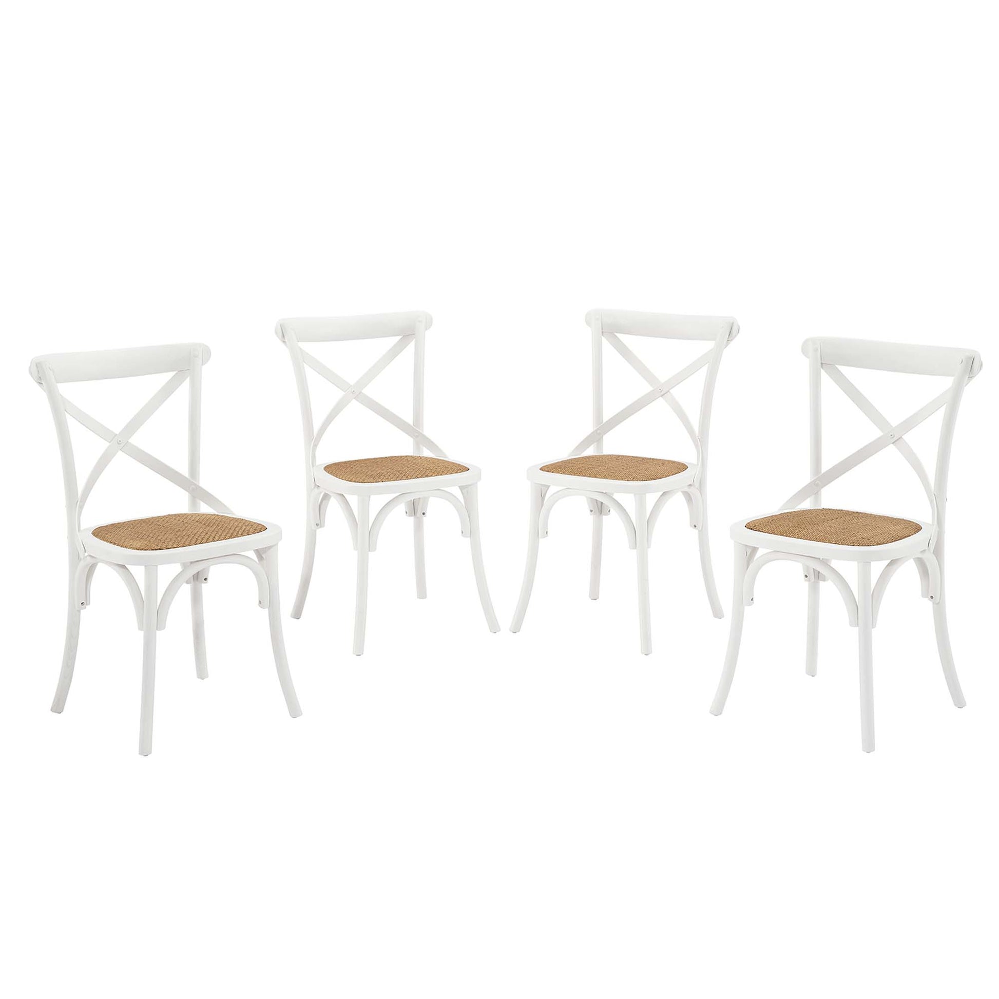 Set of four white wooden dining chairs with cross-back design and cane seats.