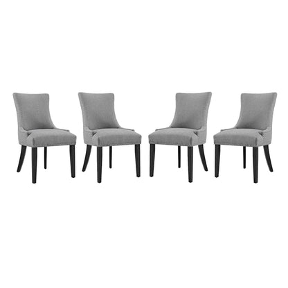 Set of four gray upholstered dining chairs with curved backs and tapered dark wood legs.