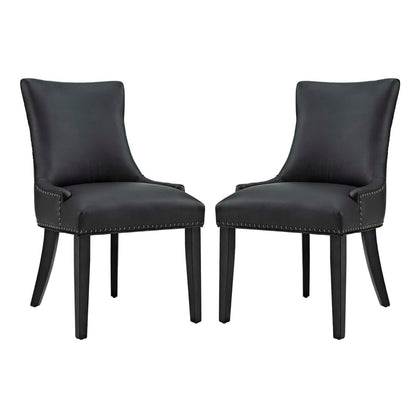 Pair of black faux-leather dining chairs with curved backs, nailhead trim, and dark wooden legs.