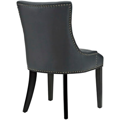 Pair of black faux leather dining chairs with nailhead trim, arched back and curved silhouette.
