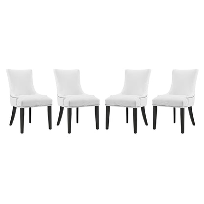 Set of four white faux leather dining chairs with dark tapered legs and nailhead trim.
