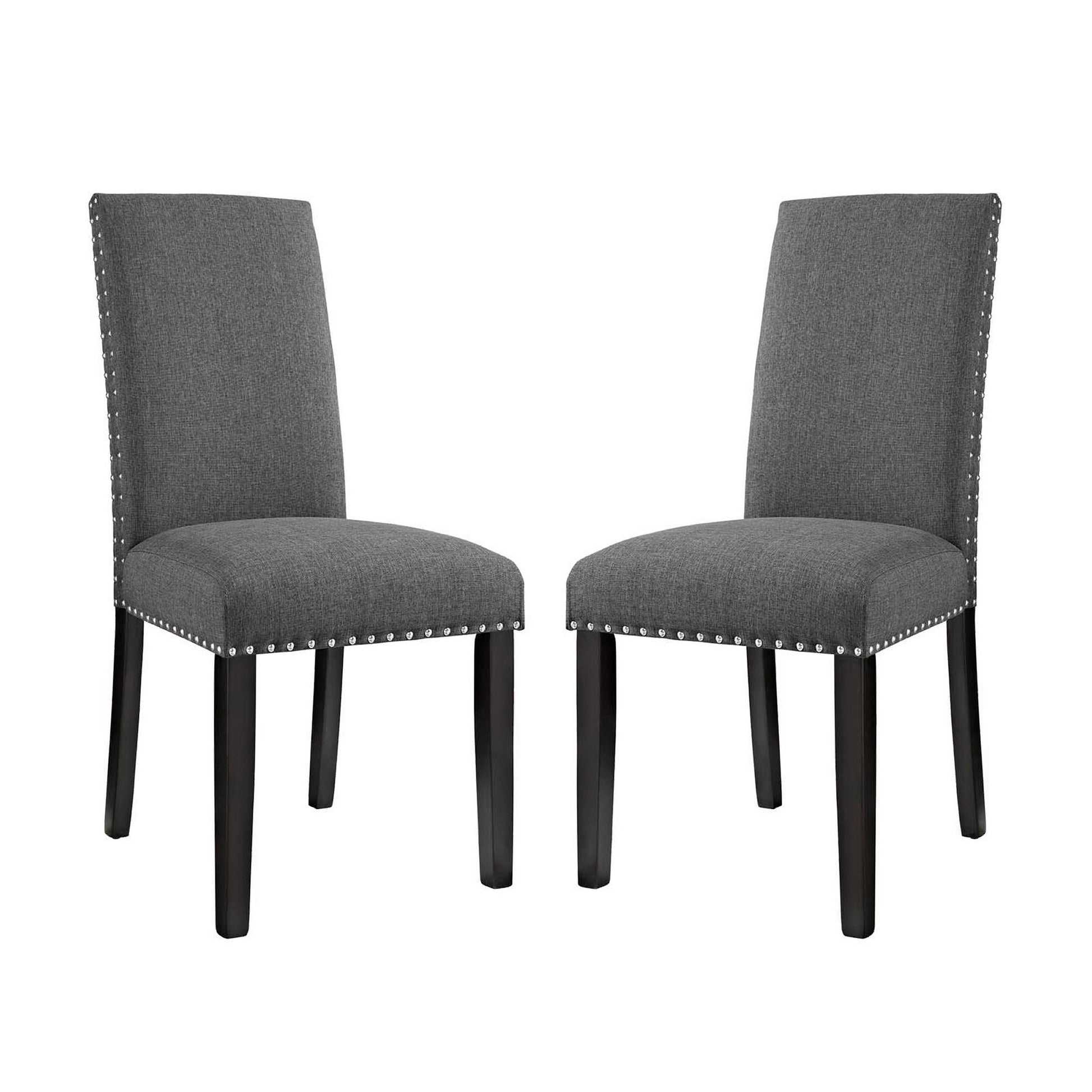Pair of gray upholstered dining chairs with tall backs, dark wood legs, and silver nailhead trim.