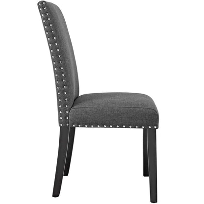 Grey fabric dining side chair set of 2 with silver nailhead trim along edges, cushioned seat, tall back, and black legs.