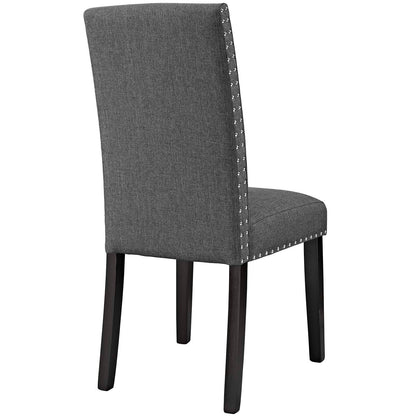 Gray upholstered dining side chair with high back, nailhead trim, and dark wood legs.