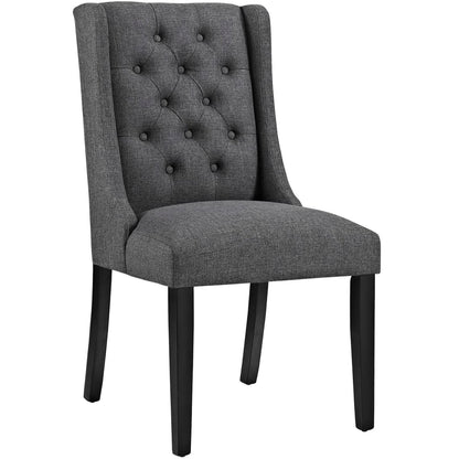 Gray fabric tufted-back dining chair with padded seat and black wooden legs.