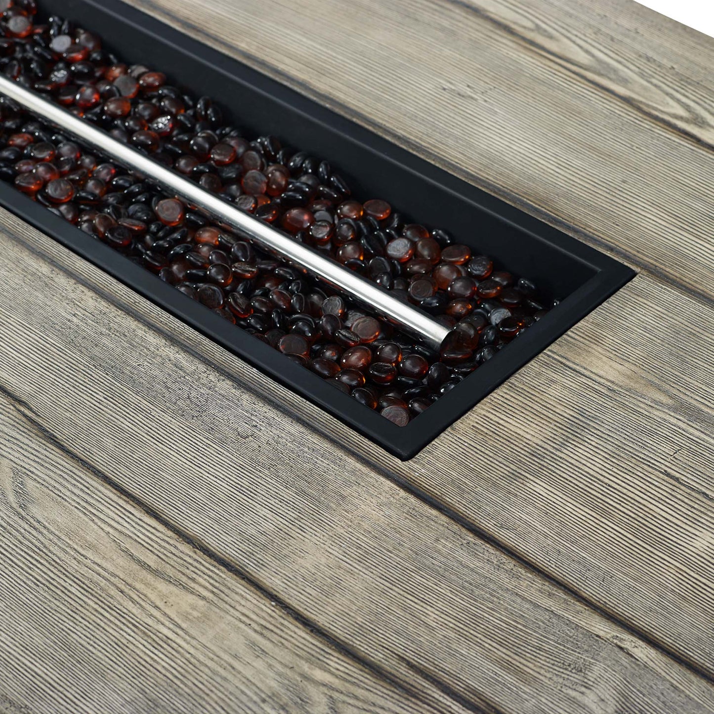 Rectangular light gray outdoor patio fire pit table on a weathered wooden deck.